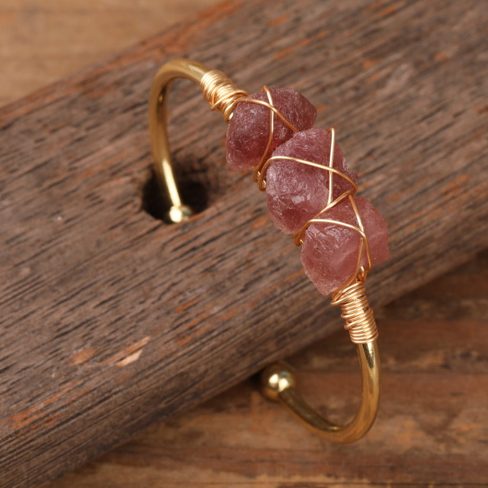 Experience the beauty of nature with Fiong Mma's Raw Crystal Bangle- A pair of our exquisitely designed Raw Crystal Bangles, handcrafted from a variety of 24 natural stones. Each bangle showcases the unique textures and colors of the stones, offering a blend of fashion and natural beauty, and reflecting a deep connection to the Earth.