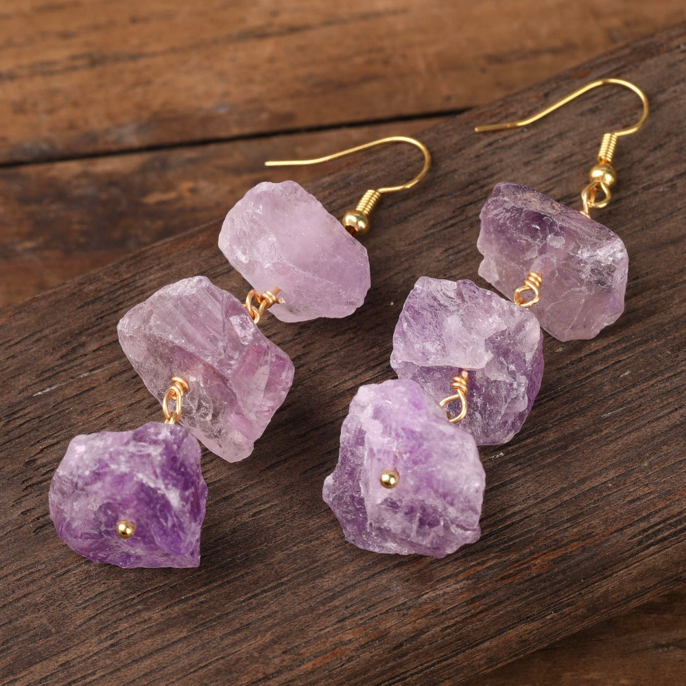 Experience the beauty of nature with Fiong Mma&#39;s Raw Crystal Earrings- A pair of our exquisitely designed Raw Crystal Earrings, handcrafted from a variety of 24 natural stones. Each earring showcases the unique textures and colors of the stones, offering a blend of fashion and natural beauty, and reflecting a deep connection to the Earth.