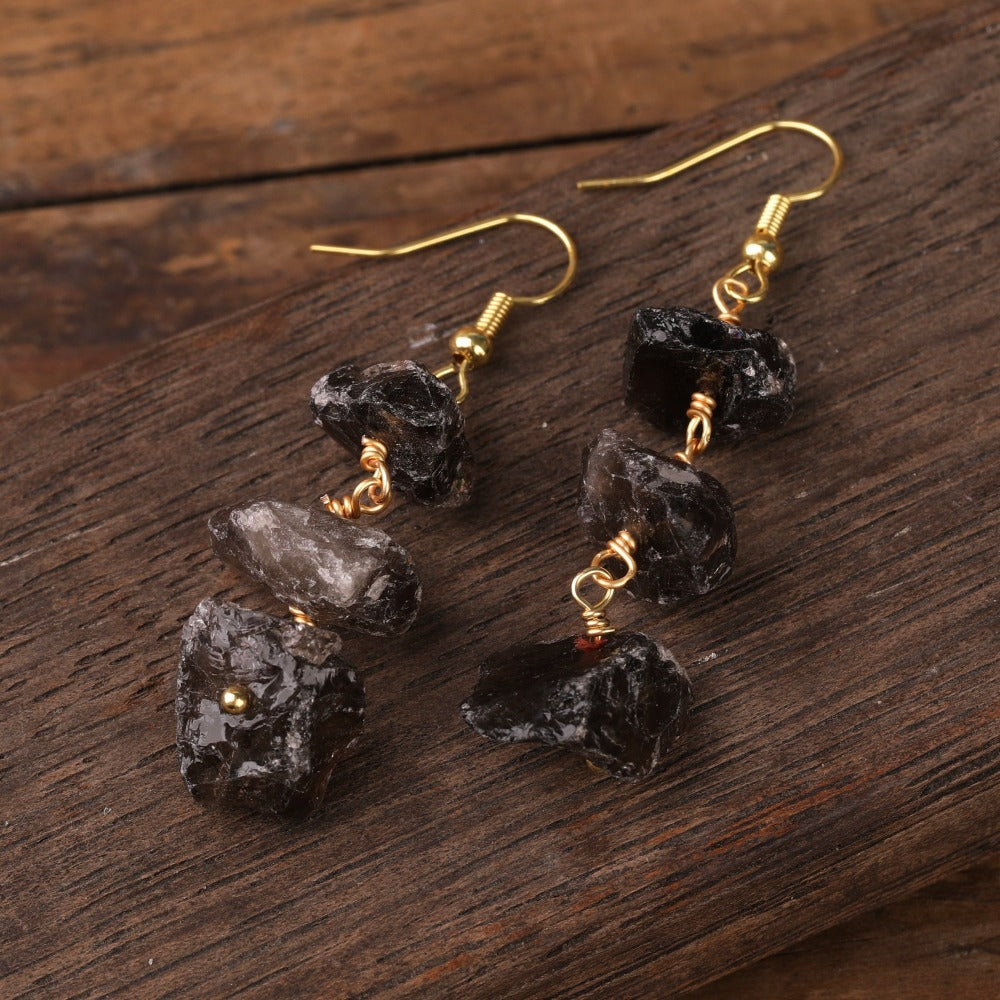 Experience the beauty of nature with Fiong Mma's Raw Crystal Earrings- A pair of our exquisitely designed Raw Crystal Earrings, handcrafted from a variety of 24 natural stones. Each earring showcases the unique textures and colors of the stones, offering a blend of fashion and natural beauty, and reflecting a deep connection to the Earth.