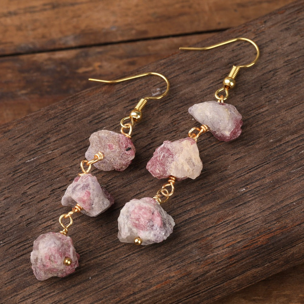 Experience the beauty of nature with Fiong Mma&#39;s Raw Crystal Earrings- A pair of our exquisitely designed Raw Crystal Earrings, handcrafted from a variety of 24 natural stones. Each earring showcases the unique textures and colors of the stones, offering a blend of fashion and natural beauty, and reflecting a deep connection to the Earth.