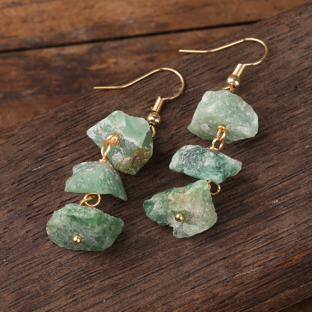 Experience the beauty of nature with Fiong Mma&#39;s Raw Crystal Earrings- A pair of our exquisitely designed Raw Crystal Earrings, handcrafted from a variety of 24 natural stones. Each earring showcases the unique textures and colors of the stones, offering a blend of fashion and natural beauty, and reflecting a deep connection to the Earth.