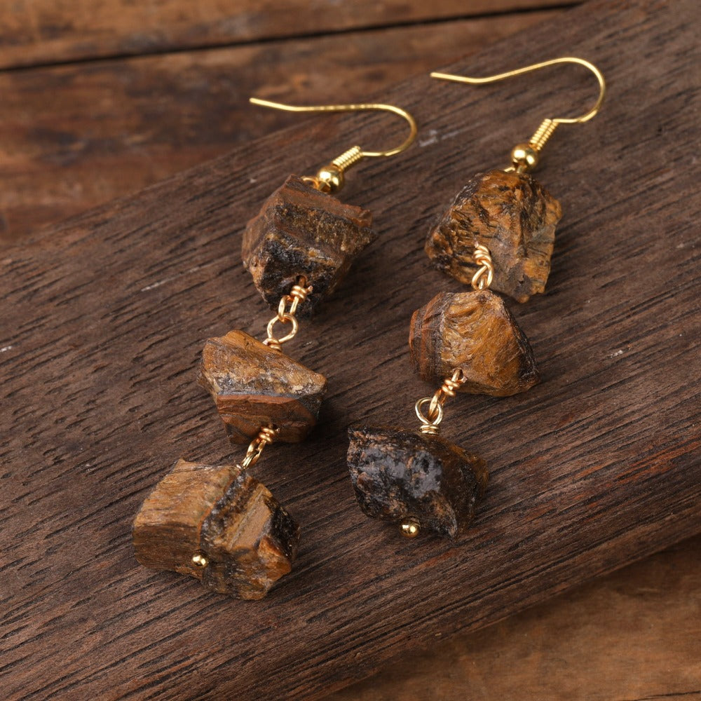 Experience the beauty of nature with Fiong Mma&#39;s Raw Crystal Earrings- A pair of our exquisitely designed Raw Crystal Earrings, handcrafted from a variety of 24 natural stones. Each earring showcases the unique textures and colors of the stones, offering a blend of fashion and natural beauty, and reflecting a deep connection to the Earth.