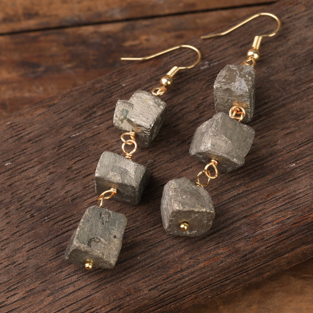 Experience the beauty of nature with Fiong Mma's Raw Crystal Earrings- A pair of our exquisitely designed Raw Crystal Earrings, handcrafted from a variety of 24 natural stones. Each earring showcases the unique textures and colors of the stones, offering a blend of fashion and natural beauty, and reflecting a deep connection to the Earth.