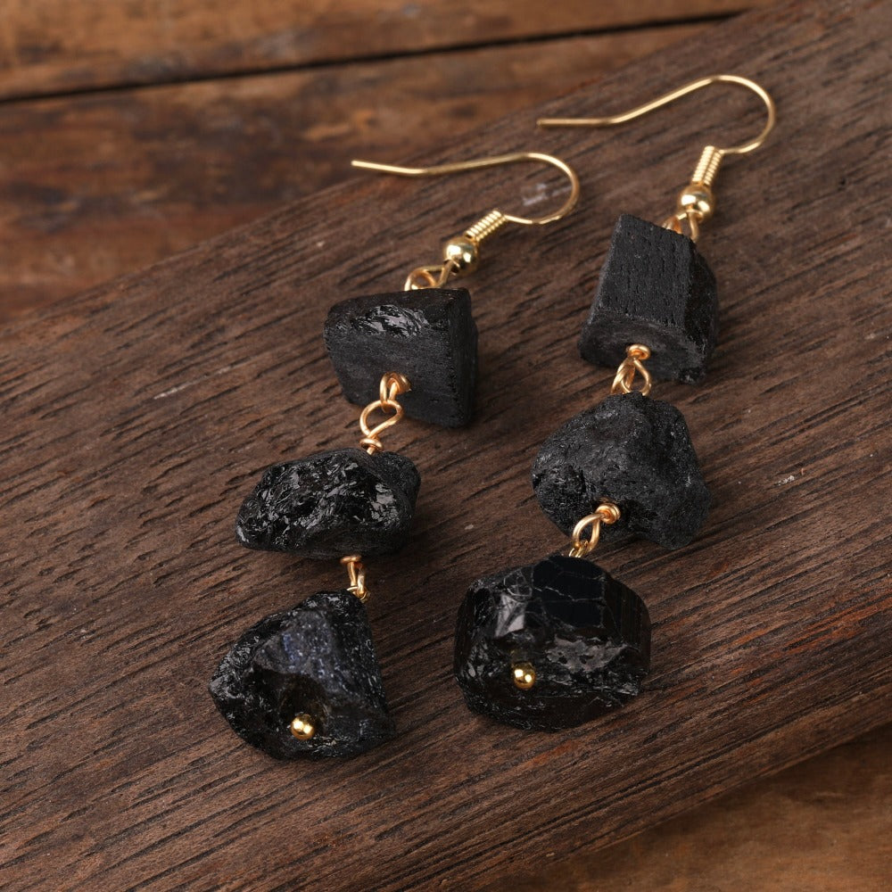 Experience the beauty of nature with Fiong Mma&#39;s Raw Crystal Earrings- A pair of our exquisitely designed Raw Crystal Earrings, handcrafted from a variety of 24 natural stones. Each earring showcases the unique textures and colors of the stones, offering a blend of fashion and natural beauty, and reflecting a deep connection to the Earth.